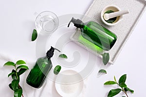 Make your own cosmetics at home with natural ingredients: green tea, sea salt. The props are arranged on a white background to