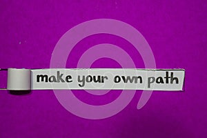 Make Your Own Path, Inspiration, Motivation and business concept on purple torn paper photo