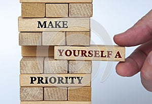 Make yourself a priority text on wooden blocks. Motivational concept.