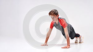 Make yourself stronger. Full-length shot of a teenage boy engaged in sport, looking focused while doing push-ups