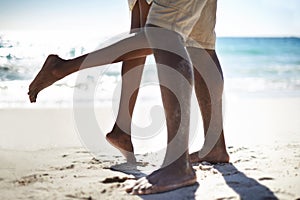 He makes her swoon. Cropped image of an african-american couple being affectionate on the beach. photo