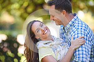 He makes me so happy. An affectionate couple outside in the summer sun.