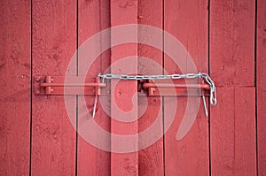 Makeshift chain lock on red barn door