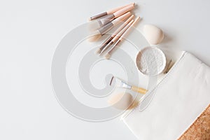 Makeup accessories, brushes and sponges,pink pastel background,flat layot