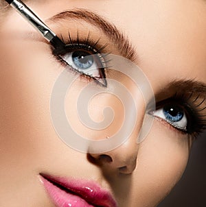 Makeup applying closeup. Eyeliner photo