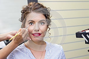 Makeup artist applies eye shadow