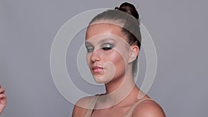 Makeup artist applies eye shadow.The concept of aesthetic cosmetology and makeup