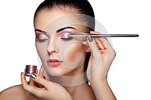 Makeup artist applies eye shadow photo