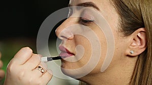 Makeup Artist Applies Lipstick On Lips Of Model