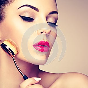 Makeup artist applies skintone with brush