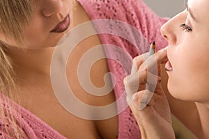 Makeup artist applying cosmetics
