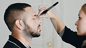 Makeup Artist Applying Makeup On Handsome Person