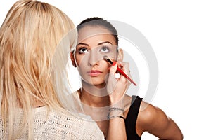 Makeup artist applying makeup to her model