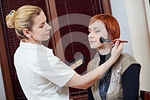 Makeup artist applying tonal cream