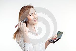 Makeup artist, beauty and cosmetics concept - Korean female make-up artist with makeup brushes and eye shadows palette