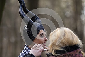 Makeup Artist Doing A Makeup for Maleficent Costume Play