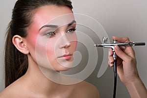 Makeup artist doing professional makeup of young woman. Makeup detail. Beauty girl with perfect skin. Beauty, make-up concept. Por