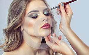 Makeup artist makes smoky eyes makeup. Applying make-up