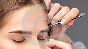 Makeup artist plucks  eyebrows in a beauty salon. Professional make-up and cosmetic skin care
