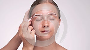 Makeup artist plucks eyebrows in a beauty salon. Professional makeup and cosmetology skin care