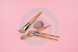 Makeup Artist`s Tools in Pink Background Brushes for Powder Gray Sponge for Concealer and Foundation Top View