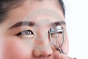 Makeup artist using eyelash curler