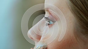 Makeup artist work in her beauty studio. Portrait of woman applying by professional make up master.