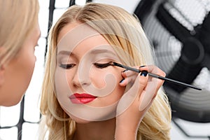 Makeup artist working with models eye makeup