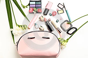 Makeup bag and set of decorative cosmetics on white background