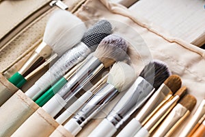 Makeup, beauty and cosmetics concept - Set of make-up brushes in a light case.