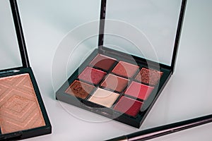 Makeup beauty cosmetics tools, products & facial cosmetics, sculptor, eye shadow stick, highlighter palette on light table. Brush,