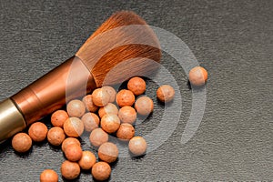 Makeup blush and brush lie on a black background. Isolate on black.