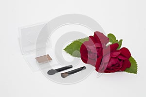 Makeup blusher rouge and brushes with red rose