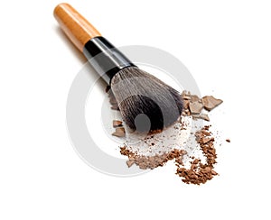 Makeup brush with color make up powder isolated on white.