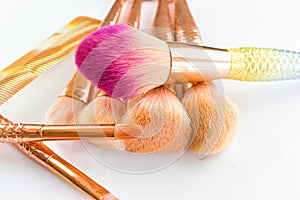 Makeup brush cosmetics on a white background