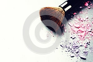 Makeup brush and crushed eyeshadows