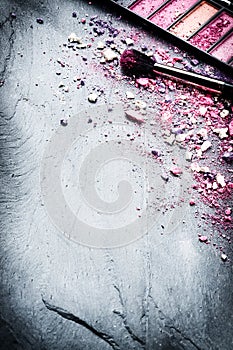 Makeup brush and crushed eyeshadows