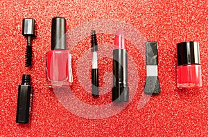 Makeup brush and decorative cosmetics on a red background