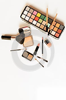 Makeup brush and decorative cosmetics on a white background