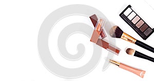 Makeup brush and decorative cosmetics on a white background