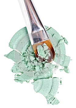 Makeup brush with green crushed eye shadow