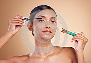 Makeup brush, portrait or woman with beauty mascara, facial products or luxury self care on studio background. Model photo