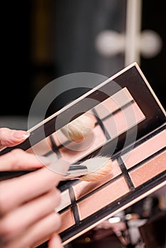 Makeup brush, the secret to perfect eyeshadow application, makeup brushes and a large beautiful golden powder compact