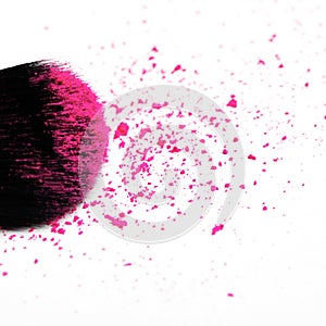 Makeup brush on white background with colorful pigment powder