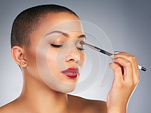 Makeup, brush and woman with red lips in studio for lipstick and mascara beauty routine. Cosmetics, confident and face