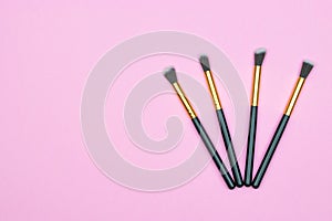 Makeup brushes powder isolated on pink with copy space. Beauty m