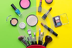 Makeup cosmetics tools background and beauty cosmetics, products and facial cosmetics package lipstick, eyeshadow on the green an