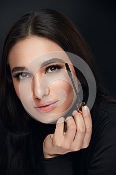 Makeup Cosmetics. Woman With Beauty Face Applying Black Mascara