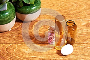 Makeup desk in cosmetics shop with golden perfume in a transparent flask