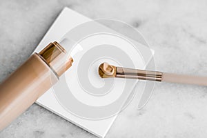 Makeup foundation bottle and contouring brush on marble, make-up concealer bb cream as cosmetics product for luxury beauty brand